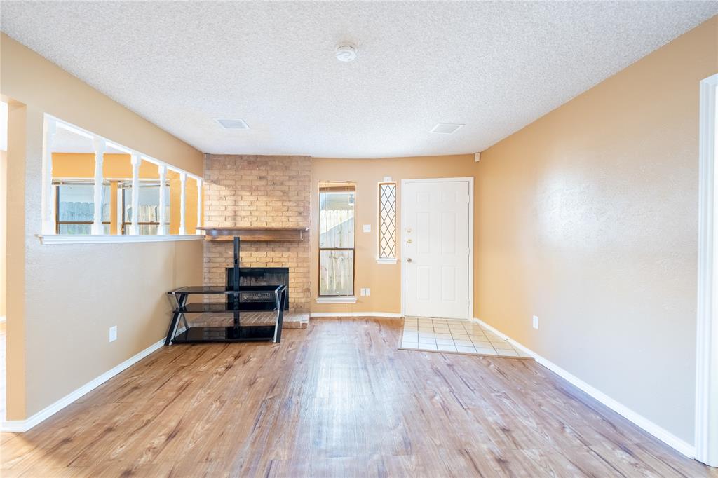 604 Windgate Court Arlington, TX 76012 - Photo 4 of 19 wooden floor in an empty room with a window