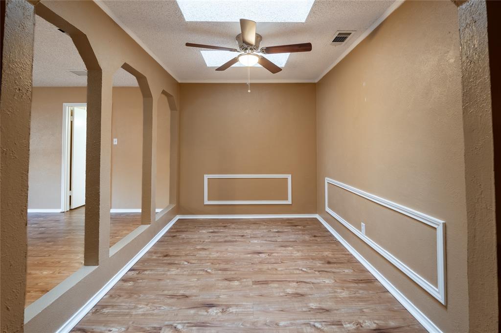 604 Windgate Court Arlington, TX 76012 - Photo 8 of 19 a view of a hallway with a chandelier