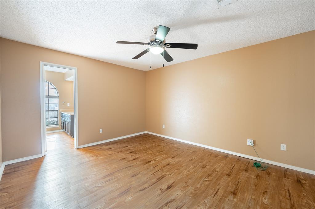604 Windgate Court Arlington, TX 76012 - Photo 9 of 19 wooden floor in an empty room and a chandelier fan