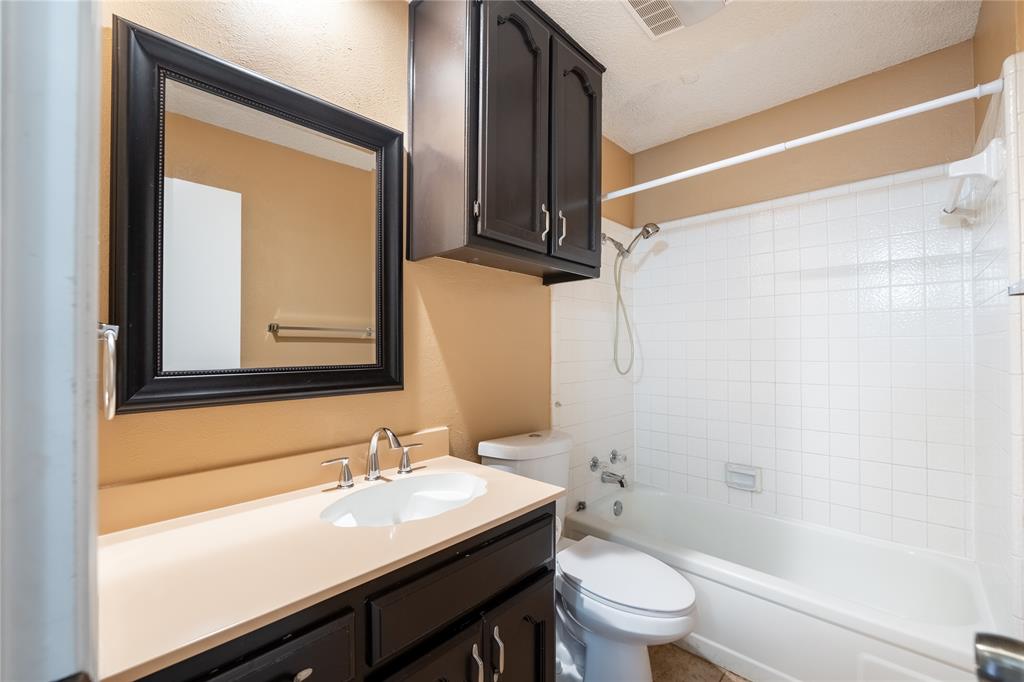 604 Windgate Court Arlington, TX 76012 - Photo 10 of 19 a bathroom with a sink a toilet and a mirror
