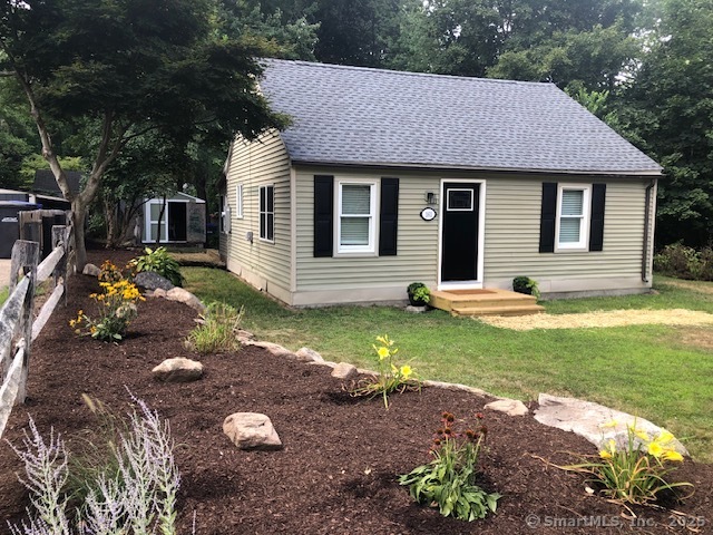 a front view of a house with garden