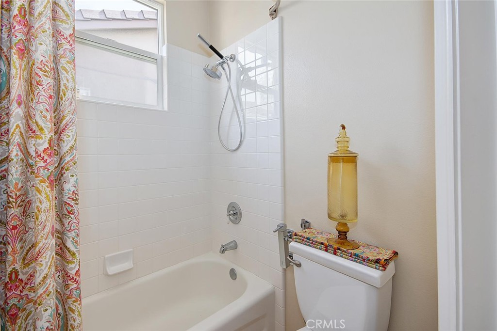 43 Carpenteria Irvine, CA 92602 - Photo 17 of 43 a bathroom with a bathtub a sink and a shower curtain