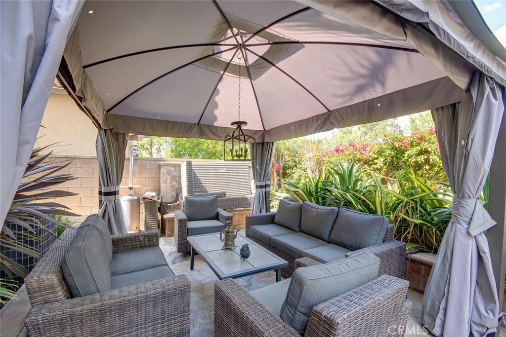 43 Carpenteria Irvine, CA 92602 - Photo 27 of 43 an outdoor living area with furniture and a umbrella