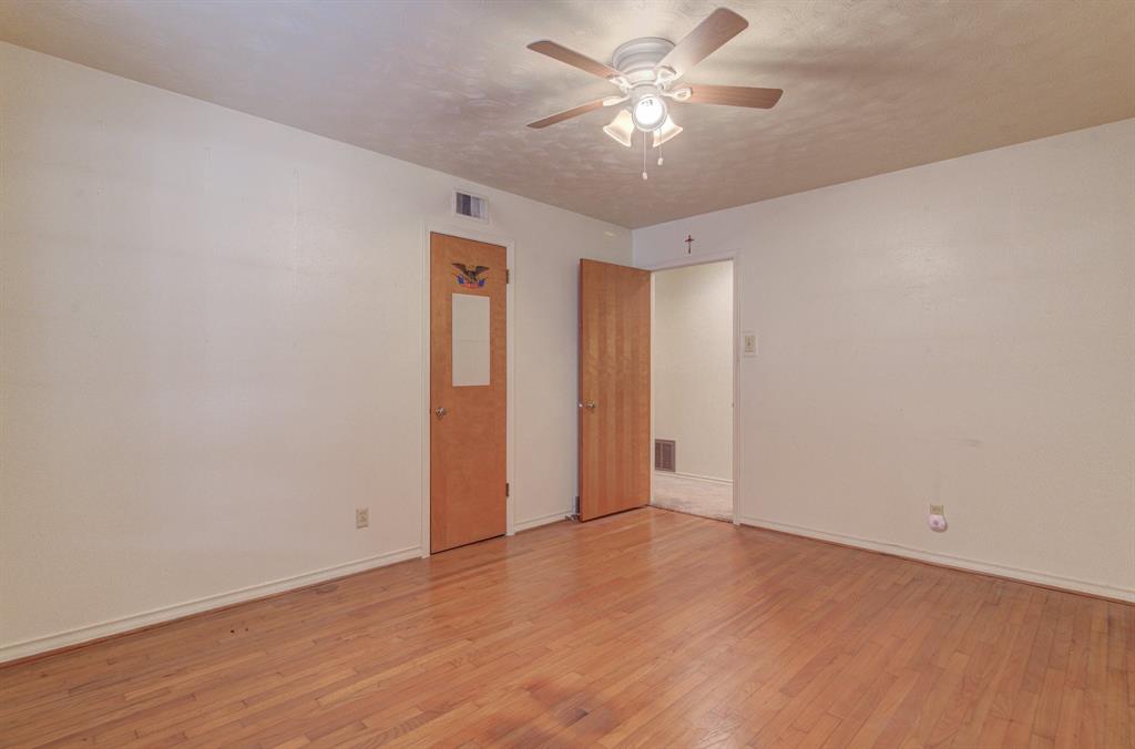 9203 Lindaro Lane Dallas, TX 75228 - Photo 22 of 32 Unfurnished room featuring light wood-style flooring, a ceiling fan, and a textured ceiling