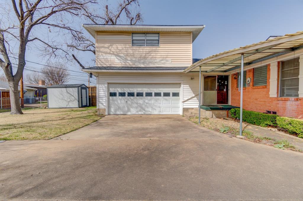 9203 Lindaro Lane Dallas, TX 75228 - Photo 30 of 32 Traditional-style home featuring driveway, an attached garage, and a front lawn