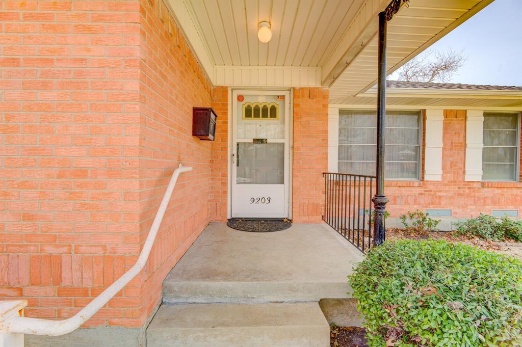 9203 Lindaro Lane Dallas, TX 75228 - Photo 4 of 32 View of exterior entry with a porch, brick siding, and crawl space