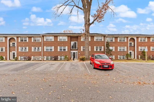 a front view of a building with parking space and parking space