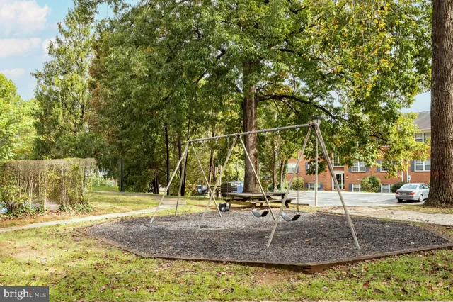 a park view with a bench and trees in the patio