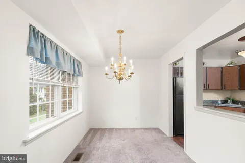 a kitchen with stainless steel appliances granite countertop a stove a refrigerator and a sink