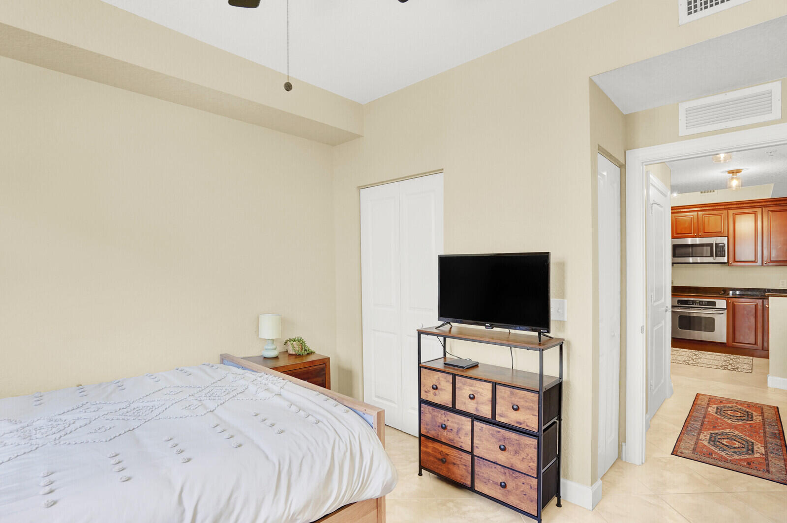 1201 Renaissance Way, Unit 201 Boynton Beach, FL 33426 - Photo 21 of 29 a bedroom with a bed and a flat screen tv