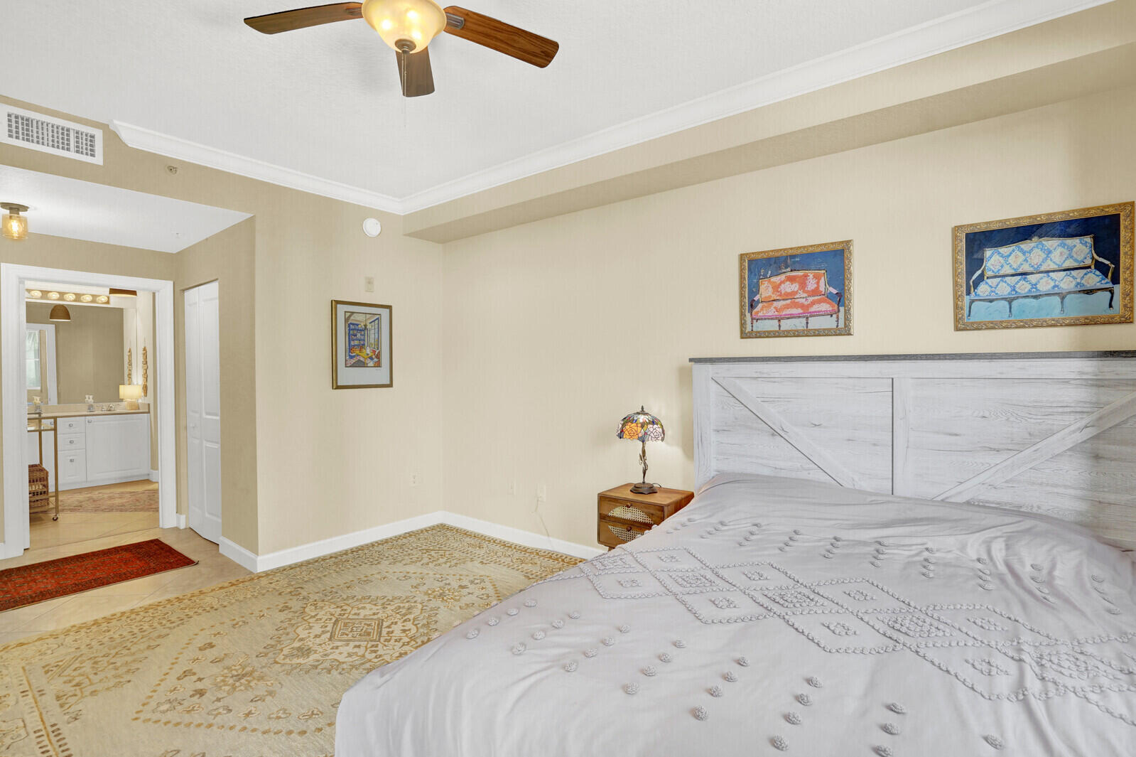 1201 Renaissance Way, Unit 201 Boynton Beach, FL 33426 - Photo 24 of 29 a bedroom with a bed and a painting on the wall