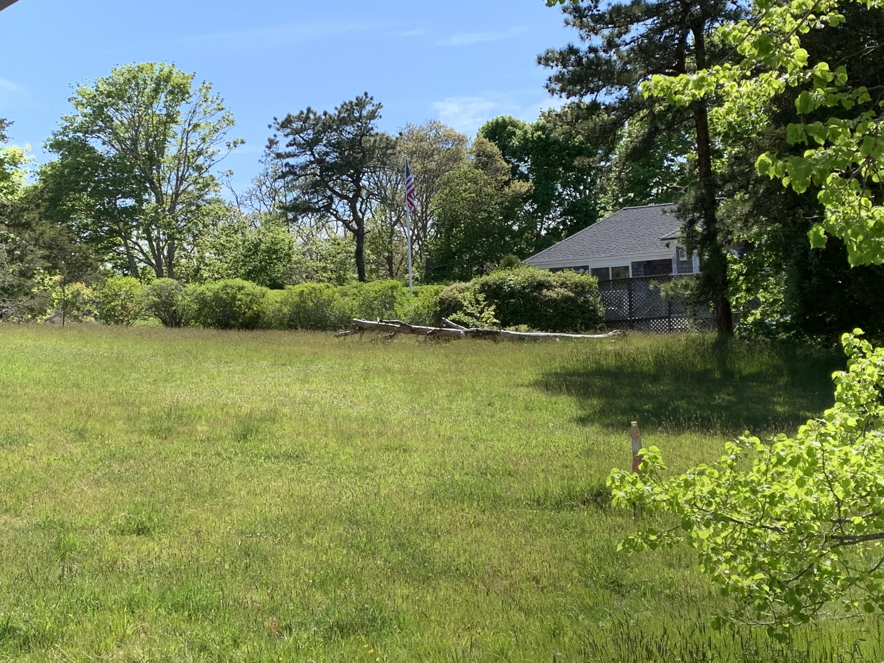 26 Cockle Cove Road Chatham, MA 02659 - Photo 4 of 8 a view of a lake with a house in the background