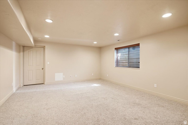 1089 West 2325th Street North Layton, UT 84041 - Photo 28 of 40 Spacious room featuring neutral carpeting, a single window with horizontal blinds, recessed ceiling lighting, and a white paneled door