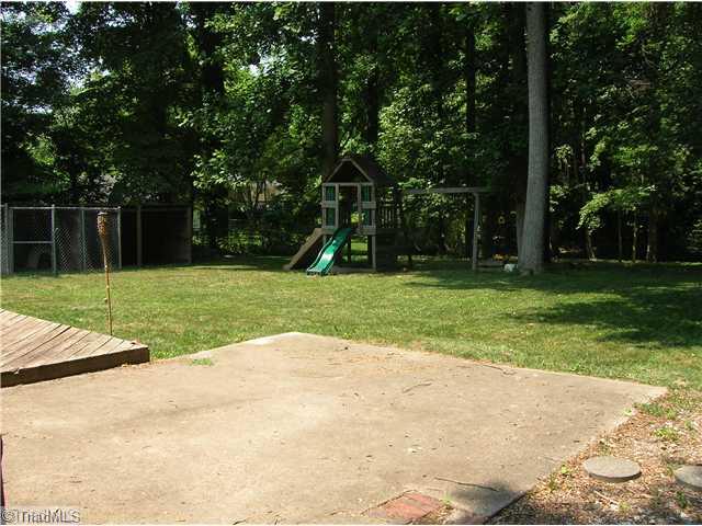 5105 Amberhill Drive Greensboro, NC 27455 - Photo 11 of 11 Exterior Back. The back yard features fencing, a concrete pad for kids to play and a deck!