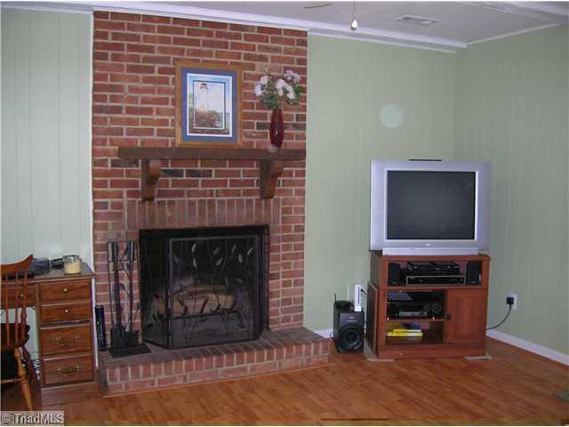 5105 Amberhill Drive Greensboro, NC 27455 - Photo 6 of 11 Den/Family/Great Room. This den is nice and cozy !! Features masonry fireplace and laminate flooring