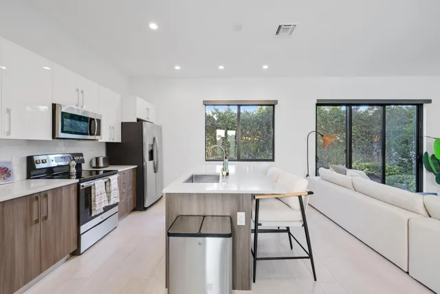 a kitchen with a stove a sink and a refrigerator