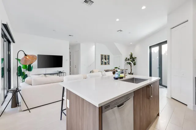 a living room with furniture and a potted plant