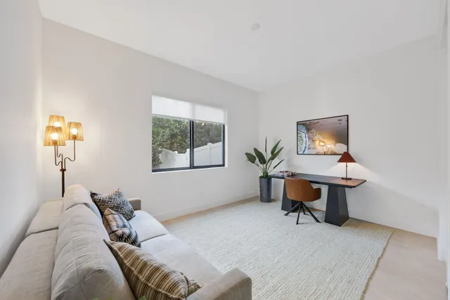 a living room with furniture and a ceiling fan