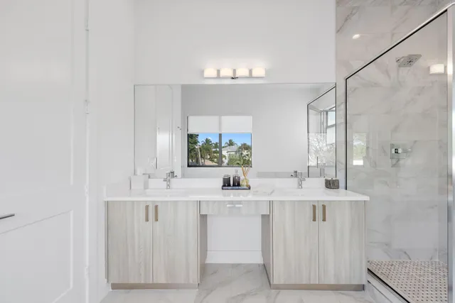 a bathroom with a bathtub a shower a sink and mirror