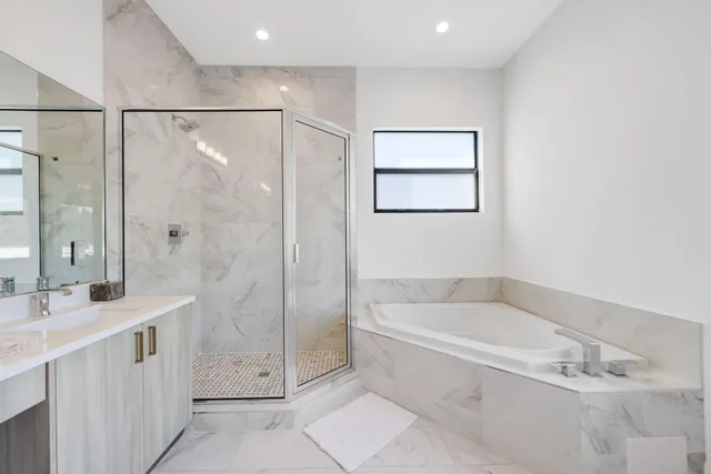 a bedroom with two beds and a large window