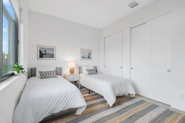 a view of room with wooden floor and white walls