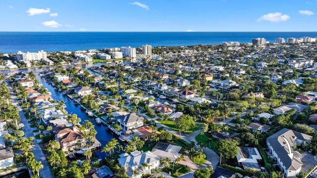 a view of a pathway with flower plants in front of house