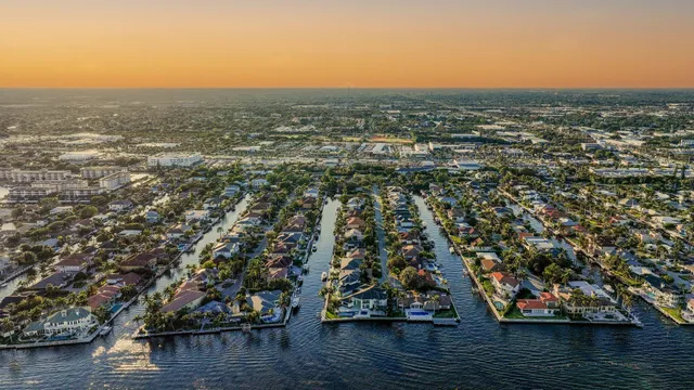 a front view of a house with garden and trees