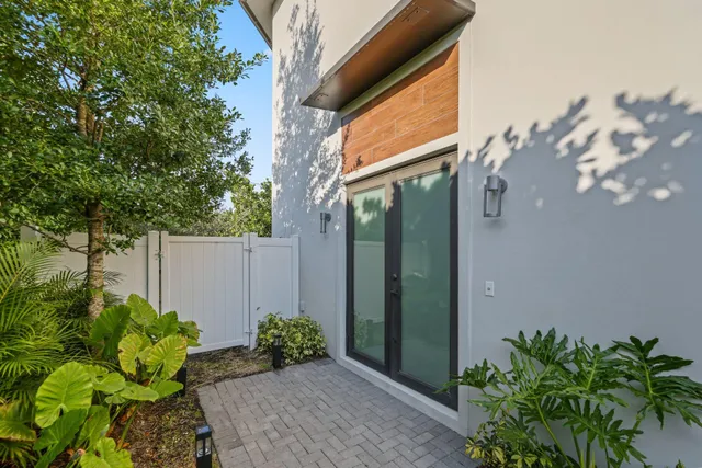 a living room with furniture a large window and a flat screen tv