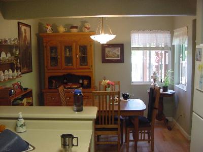 48 Regents Circle Rohnert Park, CA 94928 - Photo 4 of 6 a kitchen with a table chairs stove and cabinets
