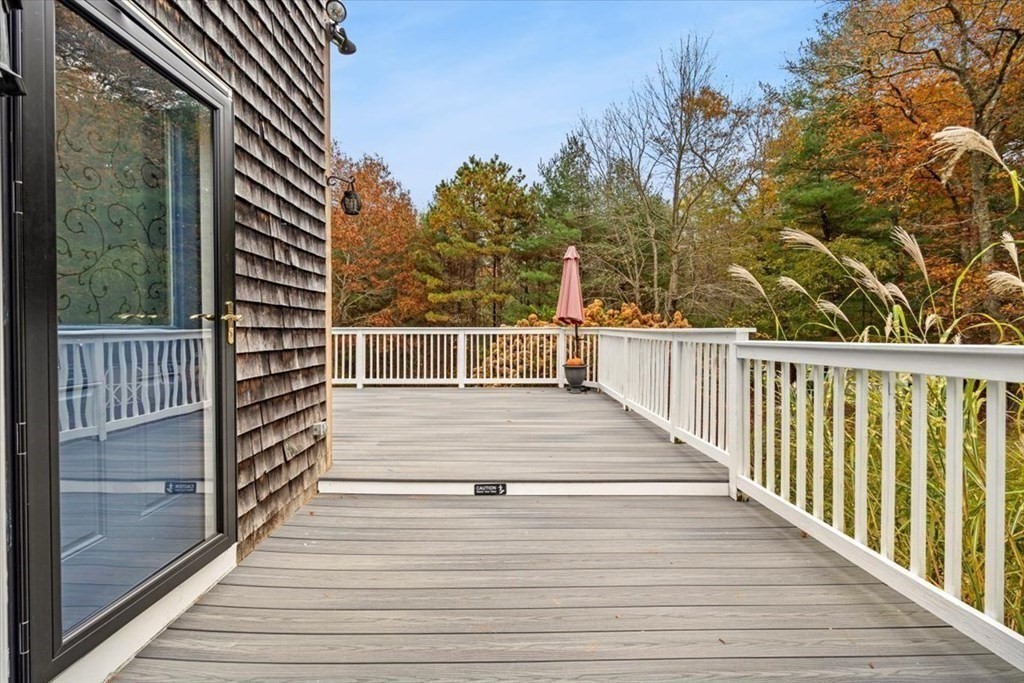 5 Stacey Road Middleboro, MA 02346 - Photo 14 of 40 a view of a balcony with wooden floor and iron fence