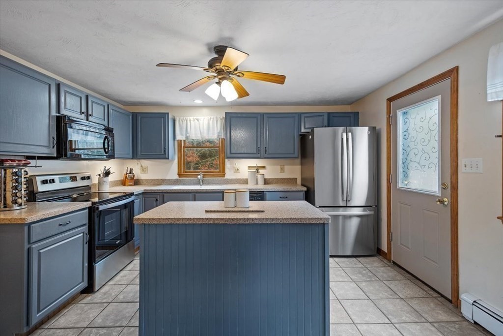 5 Stacey Road Middleboro, MA 02346 - Photo 21 of 40 a kitchen with stainless steel appliances a sink a stove a refrigerator cabinets and a window
