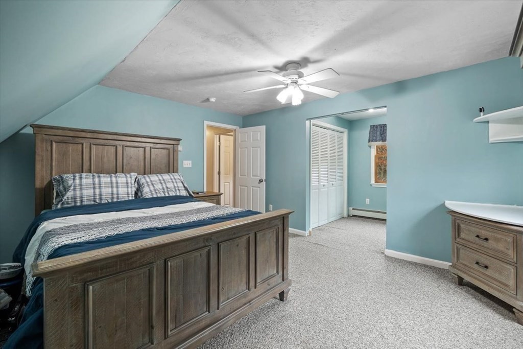 5 Stacey Road Middleboro, MA 02346 - Photo 27 of 40 a bedroom with a bed and a chandelier