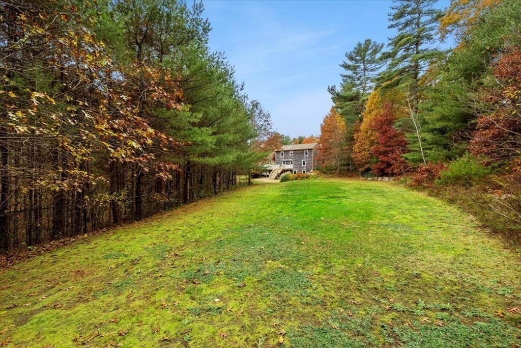 5 Stacey Road Middleboro, MA 02346 - Photo 9 of 40 a backyard of a house with plants and large trees