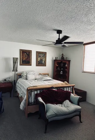 a bedroom with bed and window