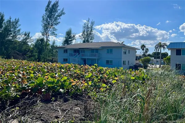 a view of a house with a flower garden