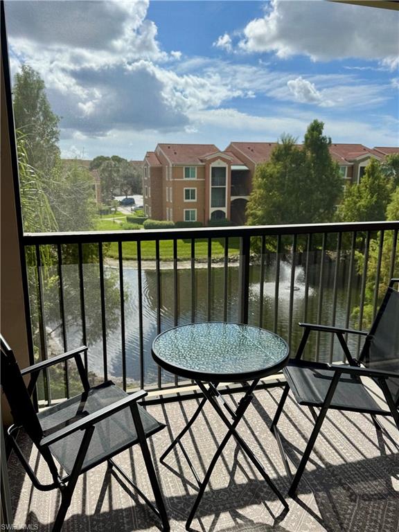 1190 Reserve Way, Unit 304 Naples, FL 34105 - Photo 11 of 20 a view of a chairs and table on the terrace