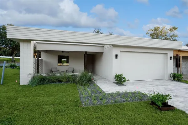 a view of a house with a yard and plants
