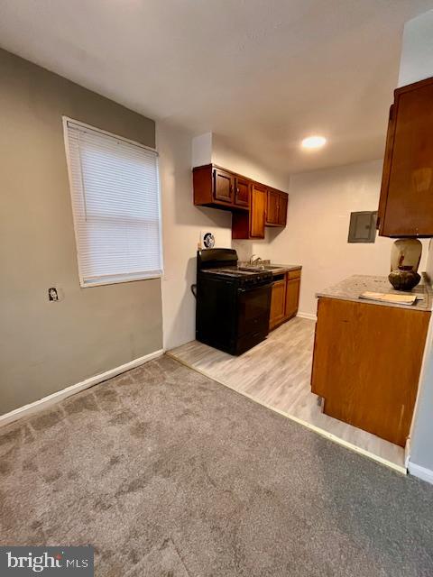 4757 South Capitol Terrace Southwest Washington, DC 20032 - Photo 5 of 18 a living room with stainless steel appliances kitchen island granite countertop a couch and a flat screen tv