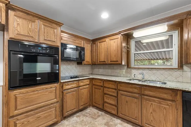 a kitchen with stainless steel appliances granite countertop a sink stove and cabinets