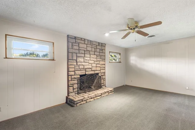 a view of an empty room with a fireplace