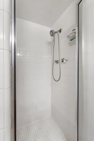 a bathroom with a glass shower door