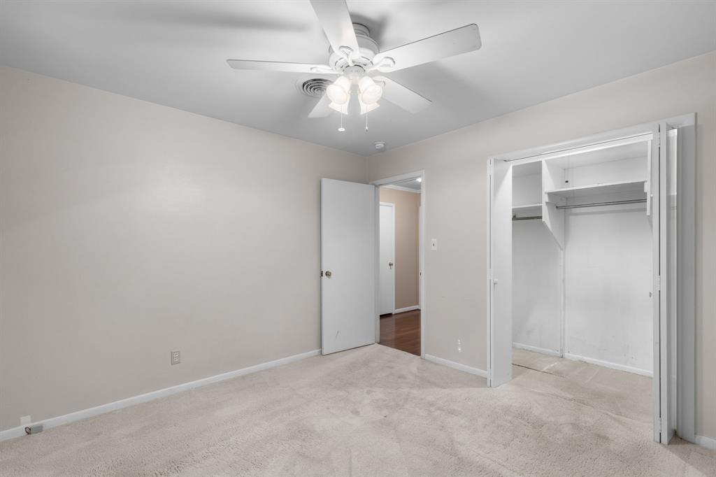 4906 Greenbriar Road Wichita Falls, TX 76302 - Photo 23 of 33 an empty room with chandelier fan and closet