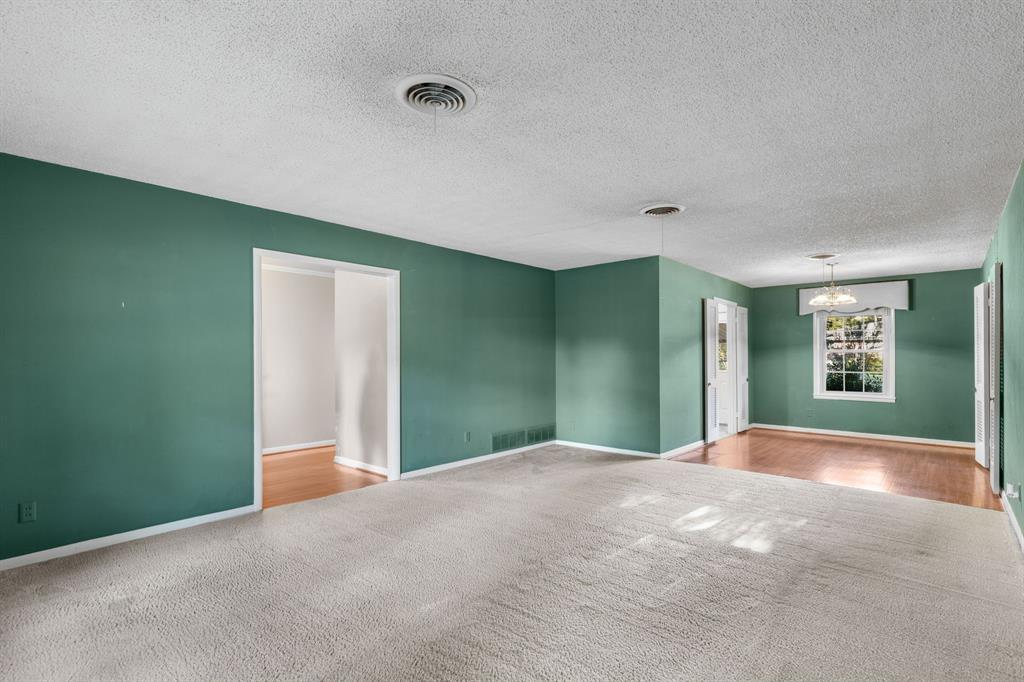 4906 Greenbriar Road Wichita Falls, TX 76302 - Photo 7 of 33 a view of a big room with windows and chandelier fan