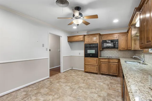 a large kitchen with cabinets and wooden floor