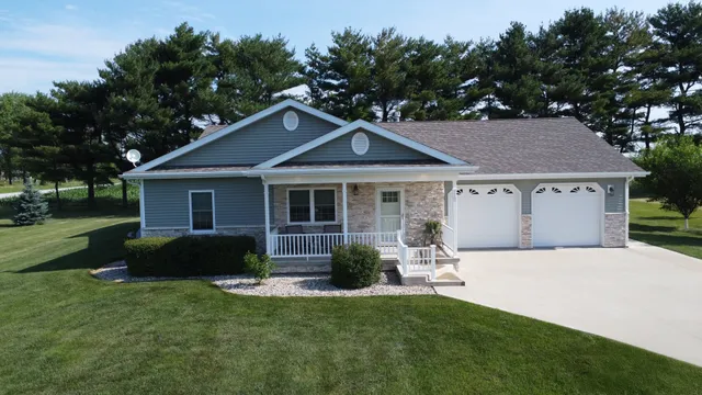 a front view of a house with a garden and yard
