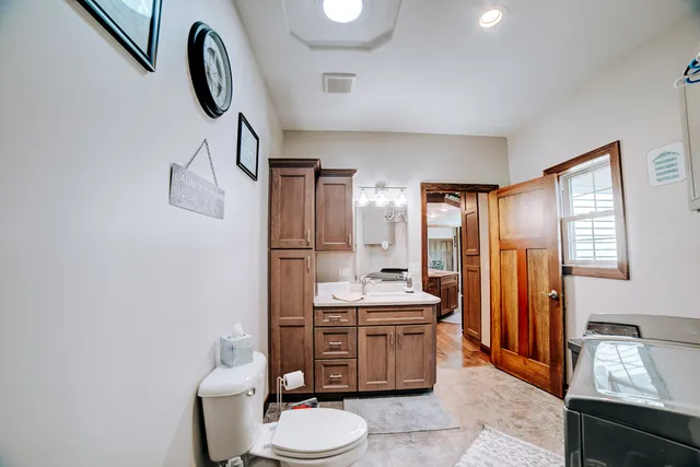 a bathroom with a toilet sink and mirror