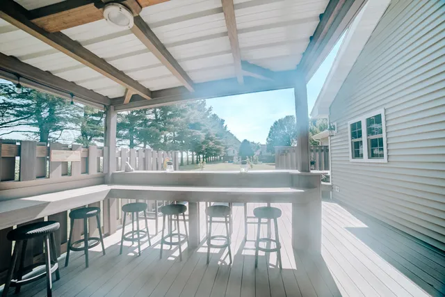 a view of a house with backyard and porch