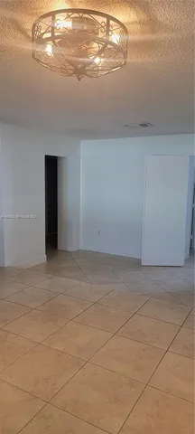 a kitchen with kitchen island granite countertop a stove and a refrigerator