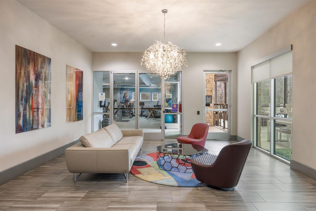 1900 Barton Springs Road, Unit 3013 Austin, TX 78704 - Photo 18 of 27 A radiant chandelier illuminates the comfortable seating area, inviting relaxation.