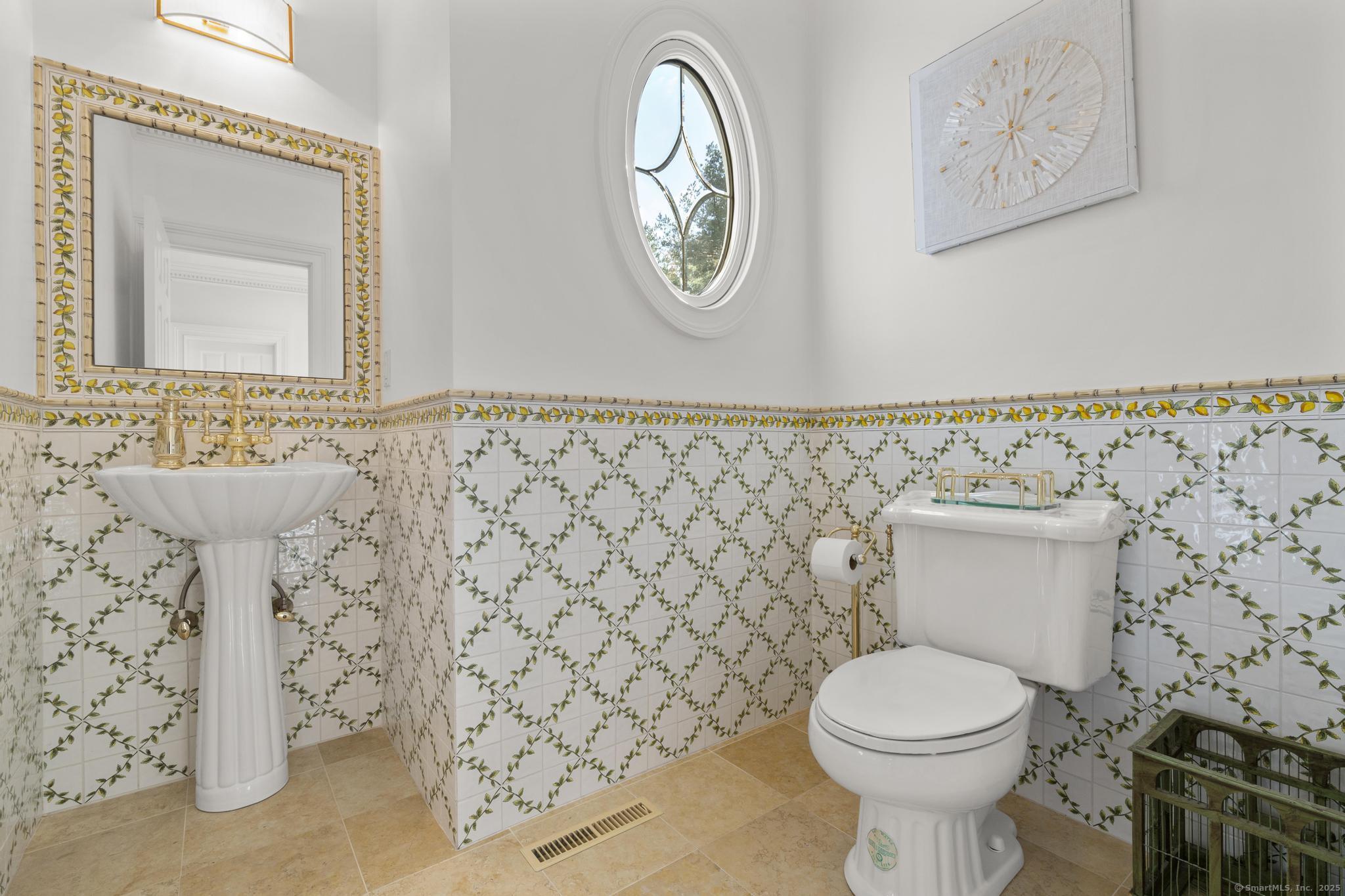 342 Midlock Road Fairfield, CT 06824 - Photo 8 of 40 Main floor powder room to the right of entry.